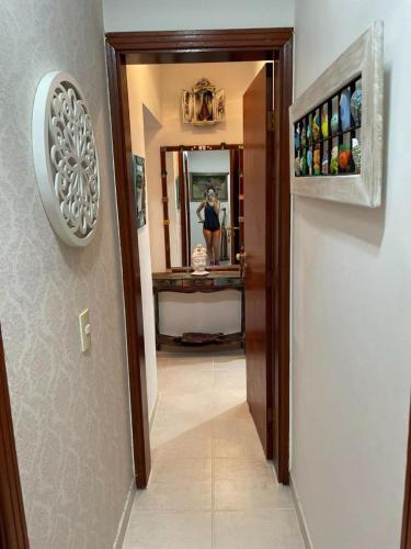 a woman taking a picture in a bathroom mirror at Linda Casa Condomínio Maresias in Maresias