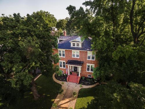 an aerial view of a large brick house with a red door at West Park Gardens in Culpeper