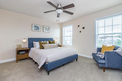 a bedroom with a blue bed and a blue chair at ConTemporary Stay in Central Peoria in Peoria