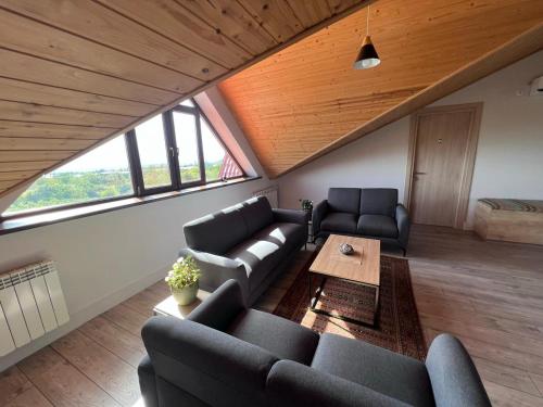 a living room with two couches and a table at Begaso Family Winery in Kvareli