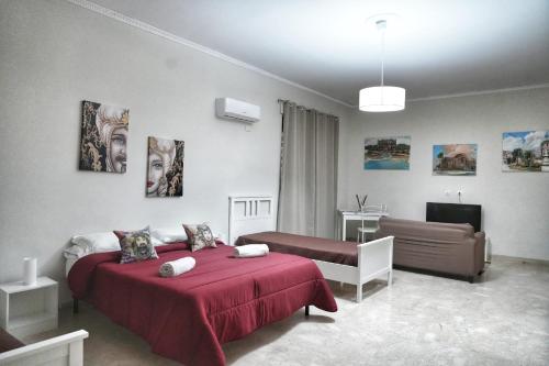 1 dormitorio con 1 cama, 1 silla y 1 sofá en La Casa del Moro - Al Politeama en Palermo