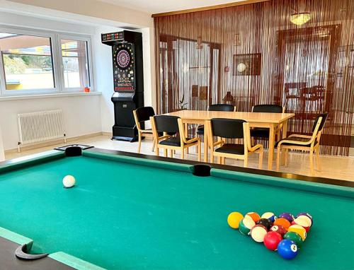 a pool table in a room with a table and chairs at Kurhotel Bad Zell in Bad Zell