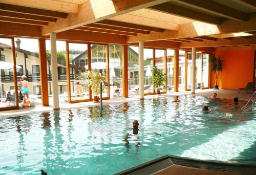 a group of people swimming in a swimming pool at Kurhotel Bad Zell in Bad Zell