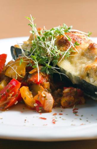 a plate of food with a piece of pizza and vegetables at Kurhotel Bad Zell in Bad Zell
