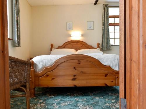 a bedroom with a large wooden bed in a room at Lower Hameldown-uk12424 in Widecombe in the Moor