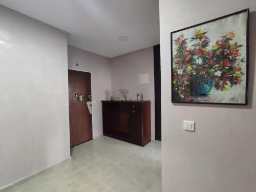 a hallway with a painting of flowers on the wall at appartement centre in Casablanca