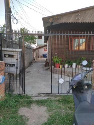 a scooter parked in front of a gate at Kitnet SIMIROMBA in Pelotas