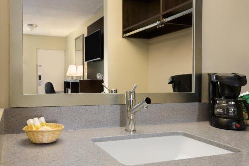 
a kitchen with a sink and a counter top at Days Inn & Suites by Wyndham Cherry Hill - Philadelphia in Cherry Hill
