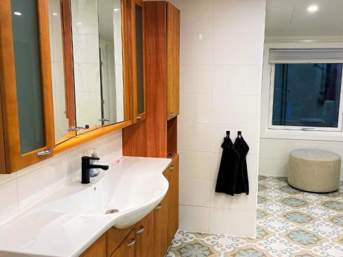 a bathroom with a sink and a mirror at Holiday home PRÄSSEBO II in Eckerud