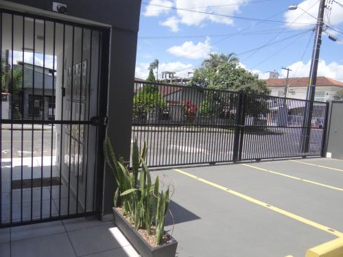 a wrought iron gate with a tennis court at BORA BORA RESIDENCE in Joinville
