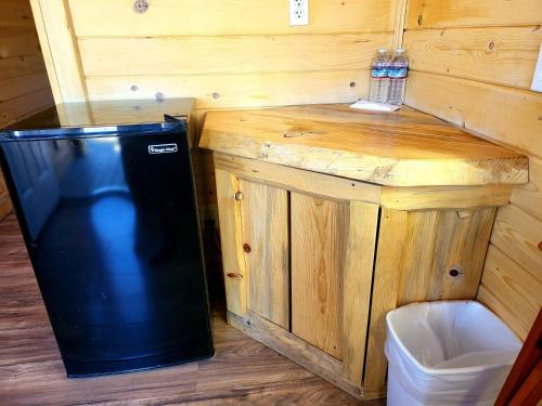 a black trash can sitting next to a wooden counter at Panamint Springs Motel & Tents in Panamint Springs