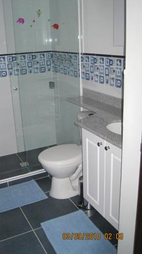 a bathroom with a toilet and a shower and a sink at International House Co-Living in Medellín