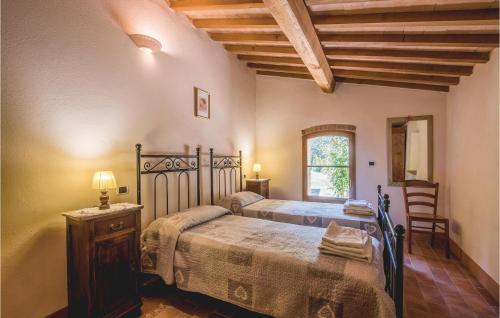 a bedroom with a bed and a table and a window at Fonterucola in Camporsevoli