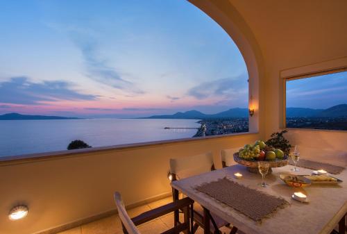 a dining room with a table and a large window at Villa Itis Superb Residence with Balcony & Panoramic View in Neapolis