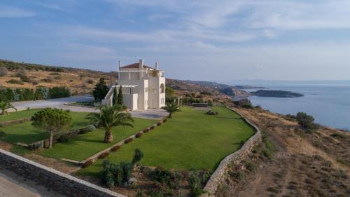 an aerial view of a house on a hill next to the ocean at Villa Itis Superb Residence with Balcony & Panoramic View in Neapolis