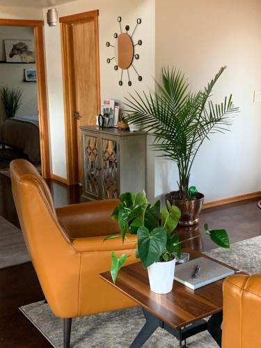 a living room with a couch and a table with plants at Hilltop Hideaway, Pacific Northwest charm & luxury in Portland