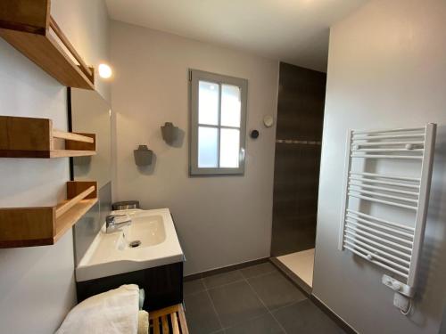 une salle de bain avec un lavabo et une douche dans l'établissement House in St Suliac near Rance River, à Saint-Suliac