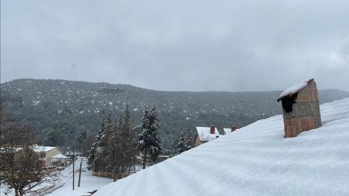 a snow covered hill with trees and a mountain at Villa ain soltan in Imouzzer Kandar