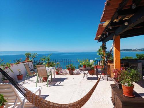 una hamaca en un patio con vistas al océano en Casa Ana Ruth (Bucerias, Nay.) en Bucerías