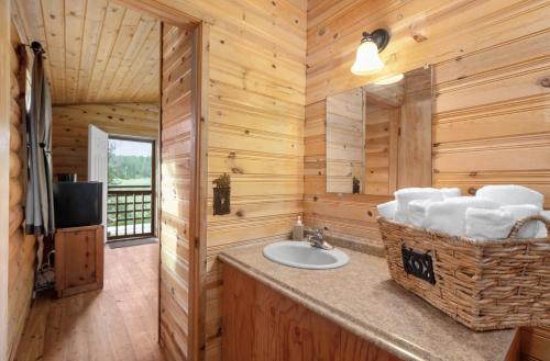 a bathroom with a sink in a log cabin at Summit Mountain Lodge and Steakhouse in East Glacier Park