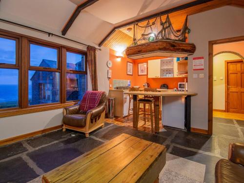 a living room with a table and a kitchen at Three Island View - W42427 in Pierowall