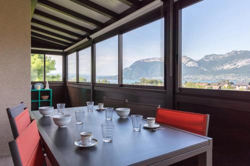 a table in a restaurant with a view of mountains at La villa panoramique in Sévrier