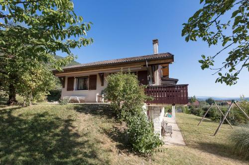 a small house with a balcony on a yard at La villa panoramique in Sévrier