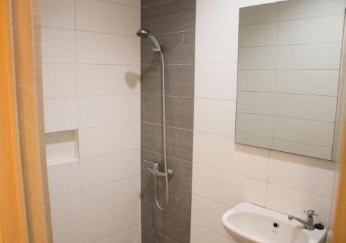 a bathroom with a shower and a sink at Kanna Stay in Semolowaru