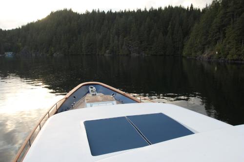 a boat on a body of water with trees at All Of Me Yacht in Richmond