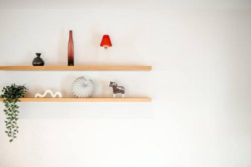 a white wall with wooden shelfs on it at Portrait Huahin in Hua Hin