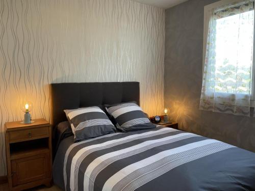 een slaapkamer met een bed met 2 kussens en een raam bij Gîte Avermes, 3 pièces, 4 personnes - FR-1-489-428 in Avermes