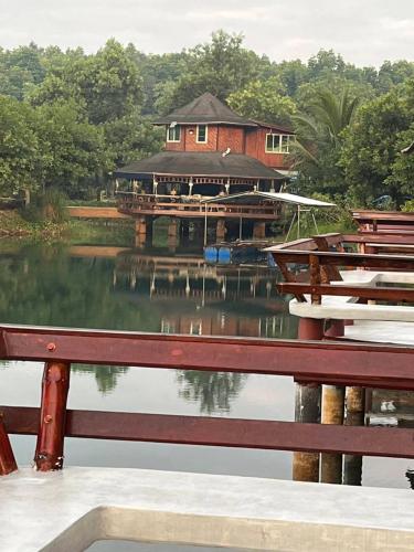 a house sitting on top of a body of water at Bungalow Together in Ban Khanim