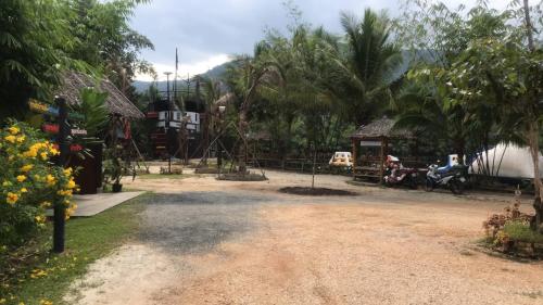 a dirt road with a playground in a resort at Bungalow Together in Ban Khanim