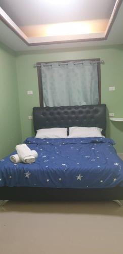 a bedroom with a blue bed with stars on it at Bungalow Together in Ban Khanim