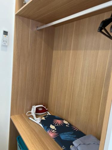a cupboard with a helmet on top of it at TheSevenBahrin Homestay in Seri Kembangan