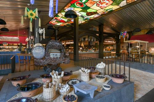 a room with a table filled with bowls and baskets at Hotel Xcaret Mexico All Parks All Fun Inclusive in Playa del Carmen