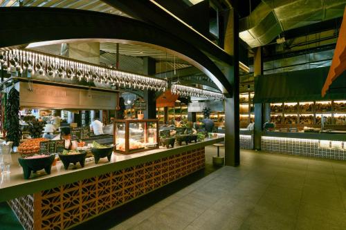 a food court in a building with a restaurant at Hotel Xcaret Mexico All Parks All Fun Inclusive in Playa del Carmen