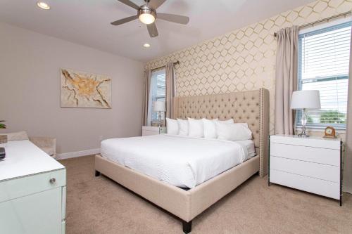 a bedroom with a bed and a ceiling fan at Luxurious 5Bd Private Pool Jacuzzi & Game Room at Encore 7432 in Orlando