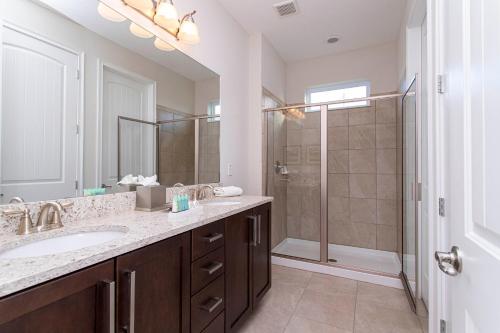 a bathroom with a large sink and a shower at Luxurious 5Bd Private Pool Jacuzzi & Game Room at Encore 7432 in Orlando