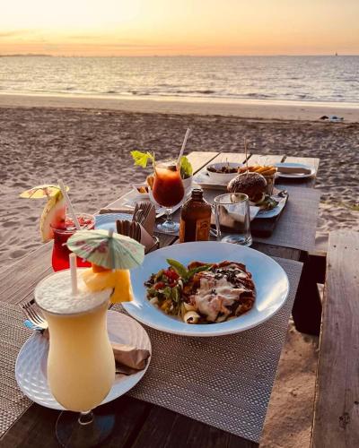 a table with a plate of food on the beach at Sailors Beach Fiji in Nadi