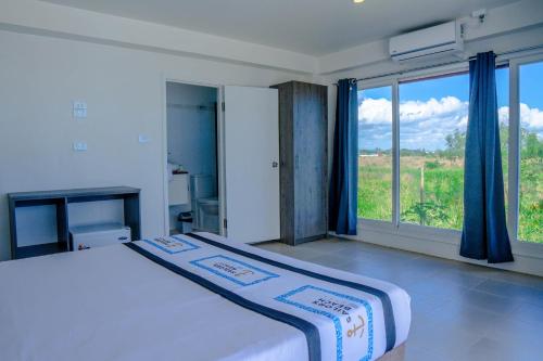 a bedroom with a bed and a large window at Sailors Beach Fiji in Nadi