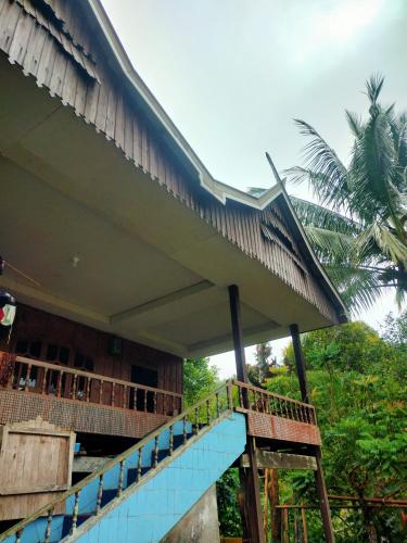 a building with a staircase leading up to it at Lajoanging Adventure Resort in Saonek