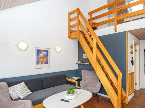 a living room with a couch and a staircase at 6 person holiday home in Fan in Fanø