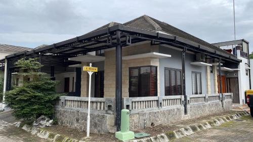 a small house with a sign in front of it at Royal Stay@Yogyakarta in Kalasan