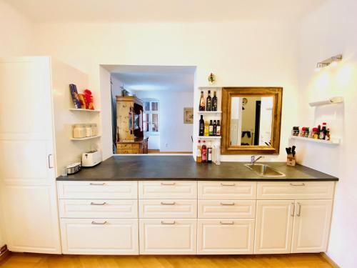 a kitchen with a sink and a mirror at Mariazeller Alpen Chalet in Mariazell