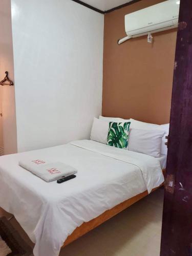 a bed in a room with a laptop on it at Kalis Viewpoint Lodge Coron in Coron