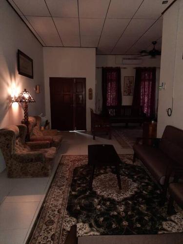 a living room with a couch and a table at T'Rai Homestay in Dungun