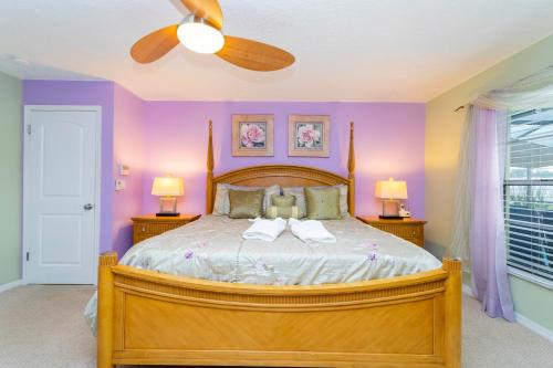 a bedroom with a bed with two towels on it at Charming 3Bd w/ Pool Close to Disney @ 7826 Indian Ridge in Orlando