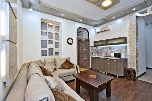 a living room with a couch and a table at Apart House in Yerevan Mashtots Avenue in Yerevan