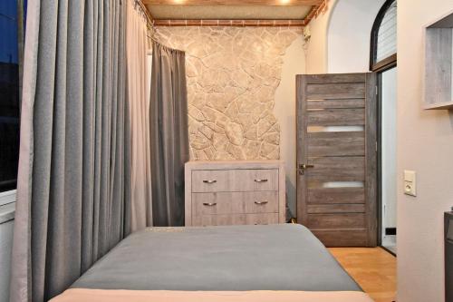 a bedroom with a bed and a dresser at Apart House in Yerevan Mashtots Avenue in Yerevan